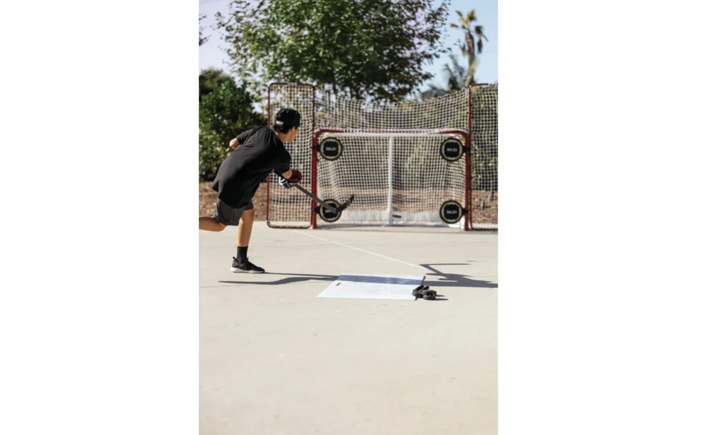 שחקן הוקי יורה על שער אימון, משטח אימונים להוקי - Avora.