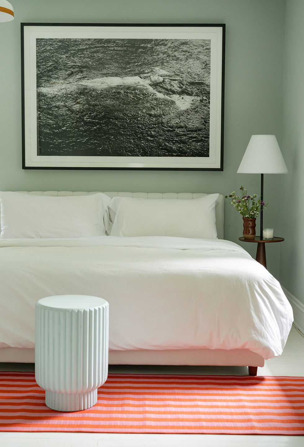 The Duet Floor Lamp on a bedside table in a bedroom.