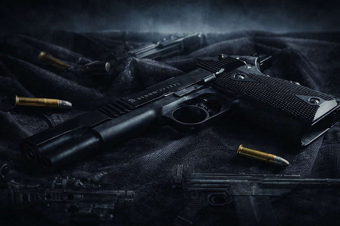 Cool-toned tactical firearms background featuring pistol, rifle and cartridges
