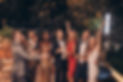Group of happy people in formalwear having fun together with confetti flying all around.jp