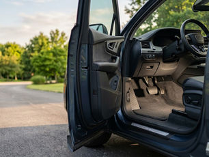 Clean SUV driver footwell showing why custom car floor mats are worth it for interior protection