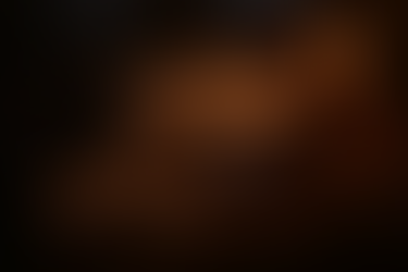 A dimly lit ritual table with a velvet cloth, leather collar, silk blindfold, and anatomical sketchbook open to a pelvic diagram. A candle glows beside glass droppers and a coiled measuring tape, evoking a serene, somatic training atmosphere. The scene is intimate and symbolic, designed to suggest erotic preparation without any nudity or human figures.