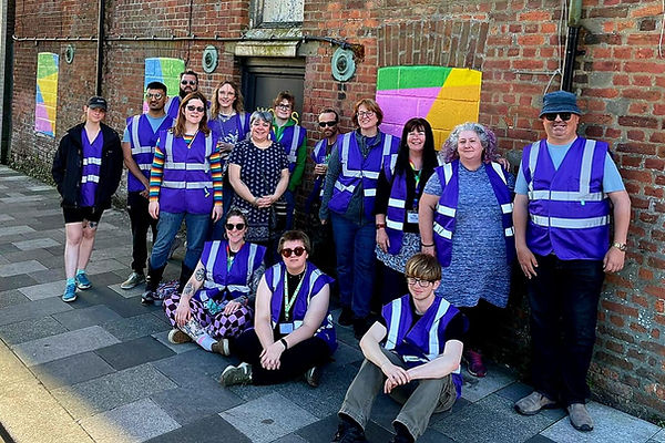 The Core team all wearing purple jackets