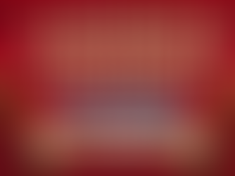 A square promotional graphic for "A Patient & Confident Waiting" set against a rich, textured dark red/crimson background featuring subtle chevron patterns. Decorative bronze corner filigree frames the image at all four corners. At the top, the bold title reads "A PATIENT & CONFIDENT" in an uppercase, 3D sand-gold serif font with soft drop shadows. Directly underneath, the word "waiting" appears in a vibrant light cyan-blue cursive script. Near the bottom, two natural dark brown complexioned hands reach upward from opposite sides, flanking a light champagne-gold banner that reads "PRAISE & PRAY (FOR OTHERS)" in dark uppercase text. Below the banner, centered text at the very bottom lists the website and social media handles: "TheMiracleAlley.com/Blog @The_Miracle_Alley | @TheFunmi"