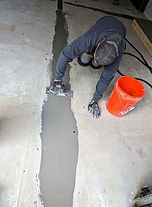 holes and cracks in cement flooring are filled before installing expoxy floor coating