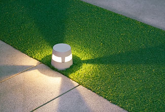 Illuminated LED Light Ground Lantern on Artificial Turf and gravel stone walkway in Front