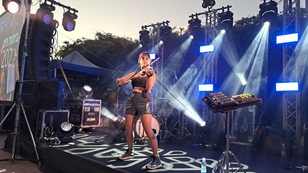 Carmit playing the violin in a event