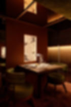 Interior of the restaurant at STORIARE, featuring deep tones and refined lighting for a luxurious dining atmosphere