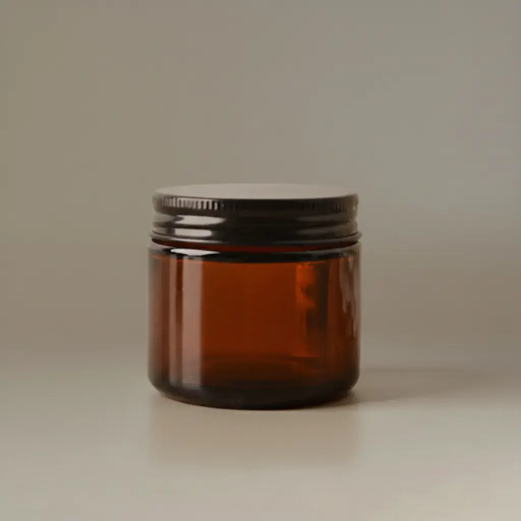 Frasco de vidrio color ámbar con tapa de rosca negra para fabricación de velas.