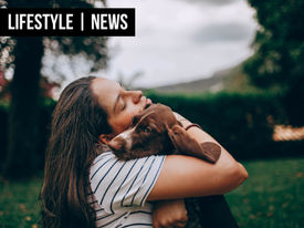 A woman embracing her dog.