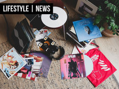 Records stacked and laying on the floor