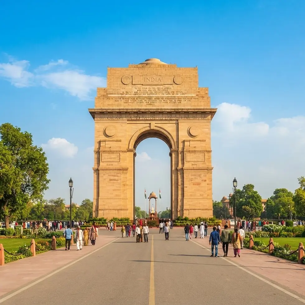 Travel photography of the India Gate war memorial in New Delhi. The iconic sandstone arch stands prominently under a clear blue sky, surrounded by a peaceful park.