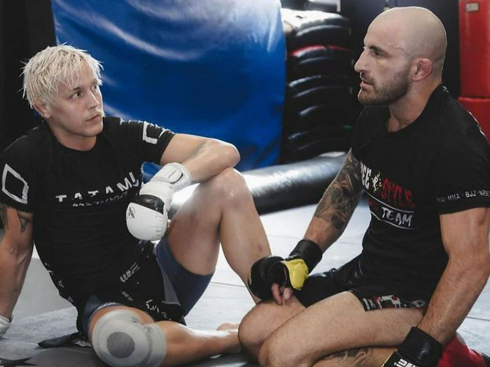 Eye-level view of a fighter practicing takedown technique on a training mat