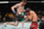 Eye-level view of an MMA fighter in action against his opponent