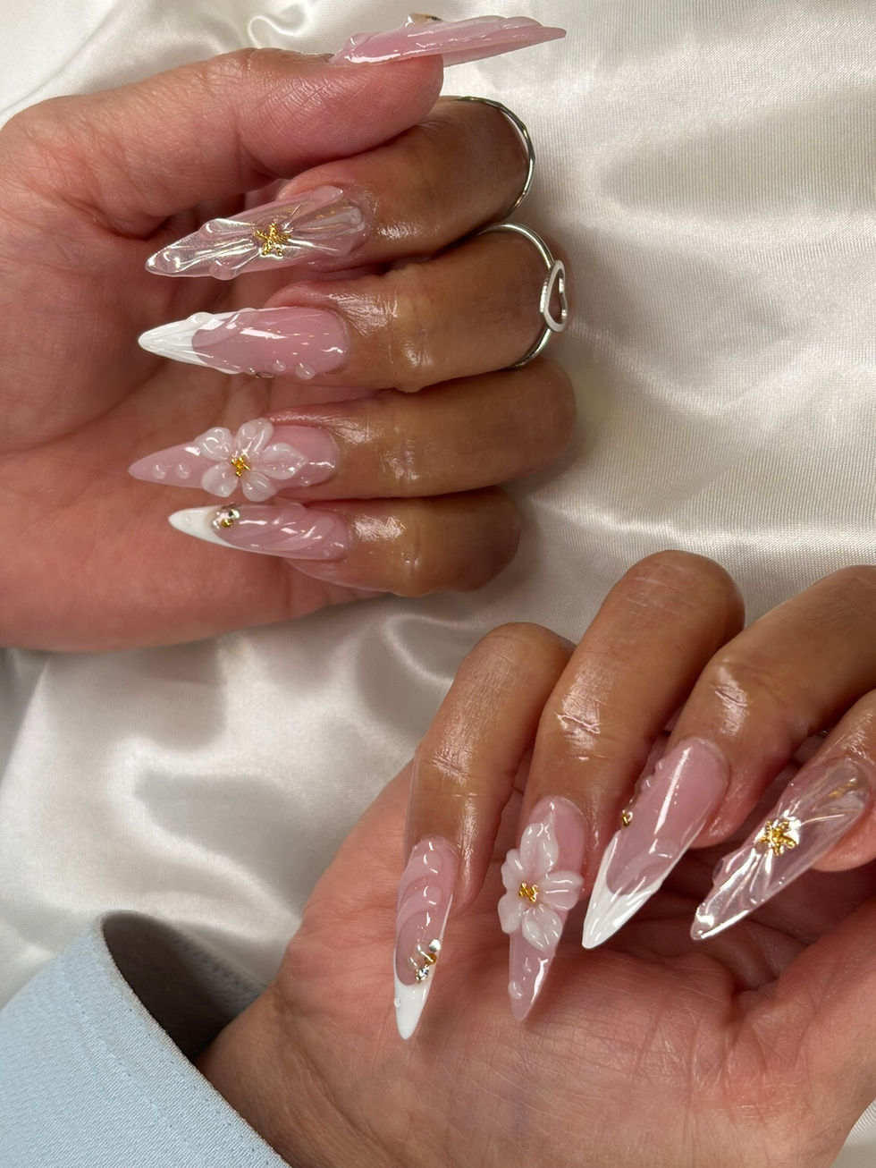 Pink stiletto nails with white French tips, 3D floral accents, and gold details at Robson Nails & Spa, downtown Vancouver