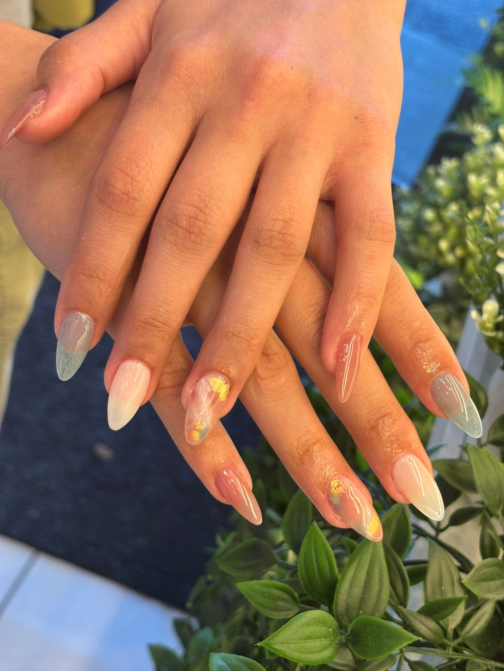 Autumn-themed almond nails with smoky grey, white, and brown tones, gold foil accents, and a glossy marbled finish.