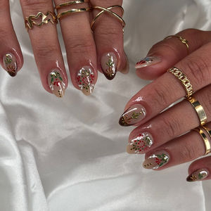 Almond nails with red, green, and blue ethnic patterns and gold accents at Robson Nails, a nail salon near me in Vancouver