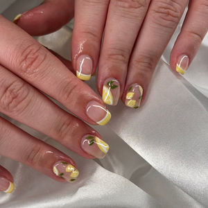 Lemon slice nail art with yellow French tips on short gel nails at Robson Nails & Spa in downtown Vancouver.