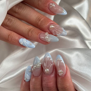 Blue and translucent nails with 3D pearls and shell accents at Robson Nails, a nail salon near me in downtown Vancouver