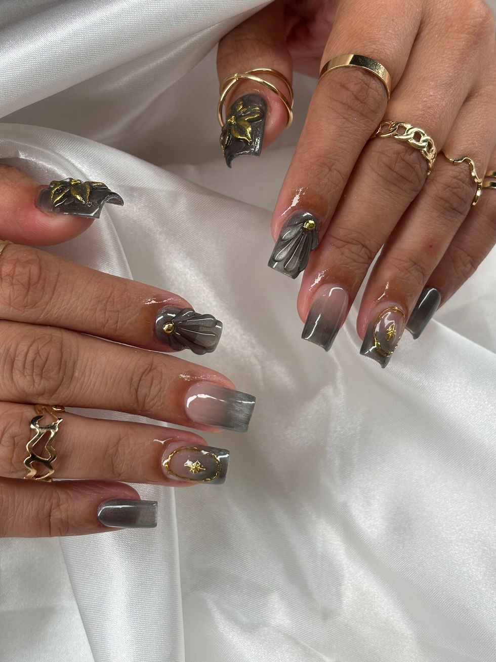 Charcoal chrome nails with clear tips, 3D petals, and gold starbursts at Robson Nails, a nail salon near me in Vancouver