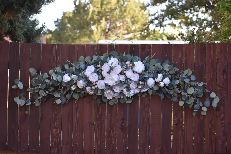 Thumbnail: Stunning 6-foot large wedding arch arbor swag featuring soft white and ivory rose & peony blossoms, lambs ear, and eucalyptus floral backdrop, perfect for adorning hanging wedding altar flowers