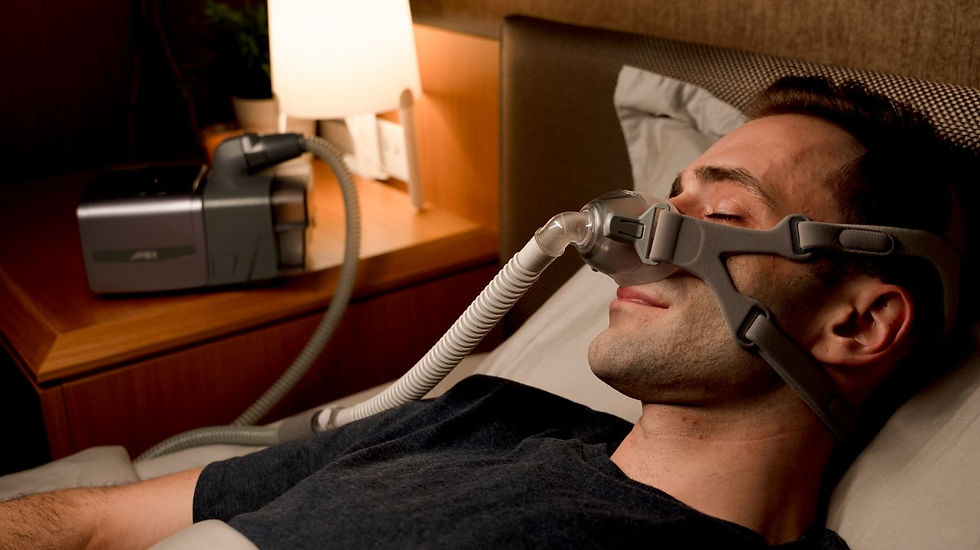 Image of a man sleeping with CPAP machine