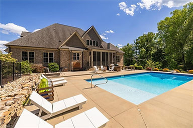 Backyard with in-ground pool and patio seating