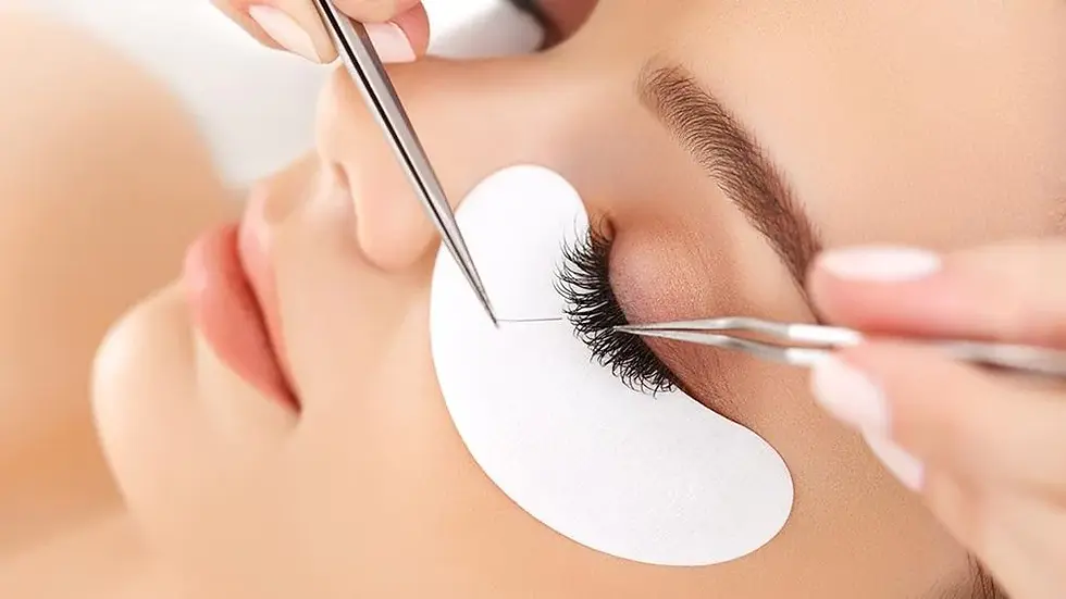 a woman getting her eyelashes done by a professional makeup artist
