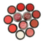 Flat lay of all 12 MIST Stockholm Lip & Cheek Tint shades in small jars, showcasing a range of creamy, velvety colors for lip