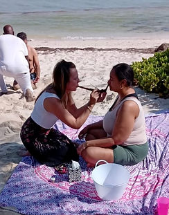 Beach service, woman serving another woman traditional sacrements