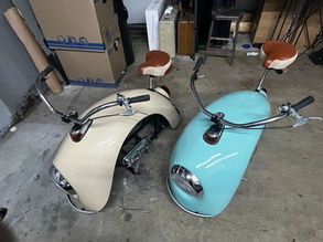 One white and one blue custom pit bike next to each other in a garage.