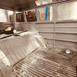 stripped down interior of VW bus during restoration.