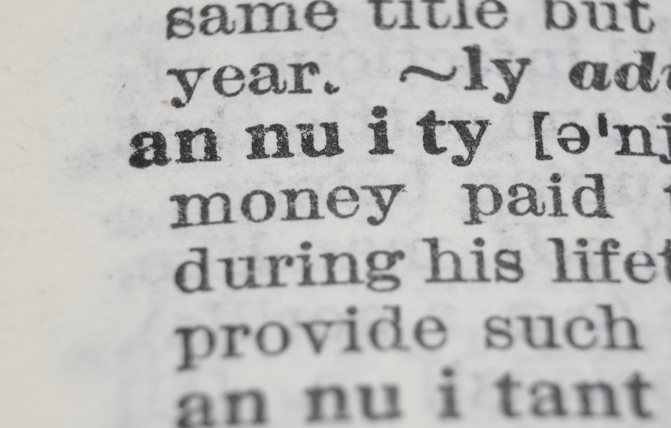 Close-up of a dictionary page showing the word "annuity" in bold. Nearby text reads "money paid during his life." Black type on white paper.