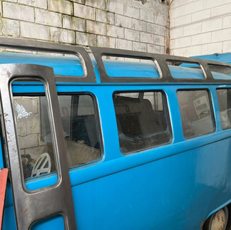 Blue VW Bus before restoration, side view.