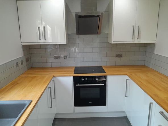 A new kitchen, backsplash tiling was completed by Paul J Russell, wooden worktops and white cabinet