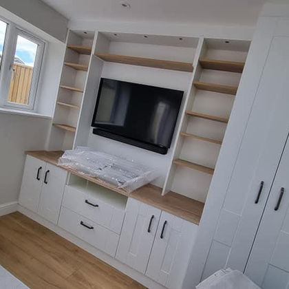 White built-in media wall with TV and storage