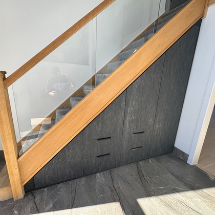 Bespoke under-stair storage with dark gray doors