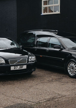 Two black cars, part of John Brown And Daughters fleet of funeral cars