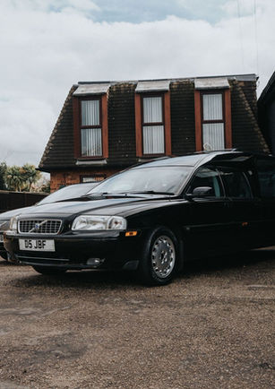 Two black cars, part of John Brown And Daughters fleet of funeral cars