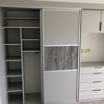 Fitted wardrobe with shelving and sliding doors