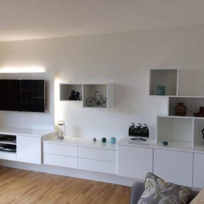 Modern white media wall with TV and shelving
