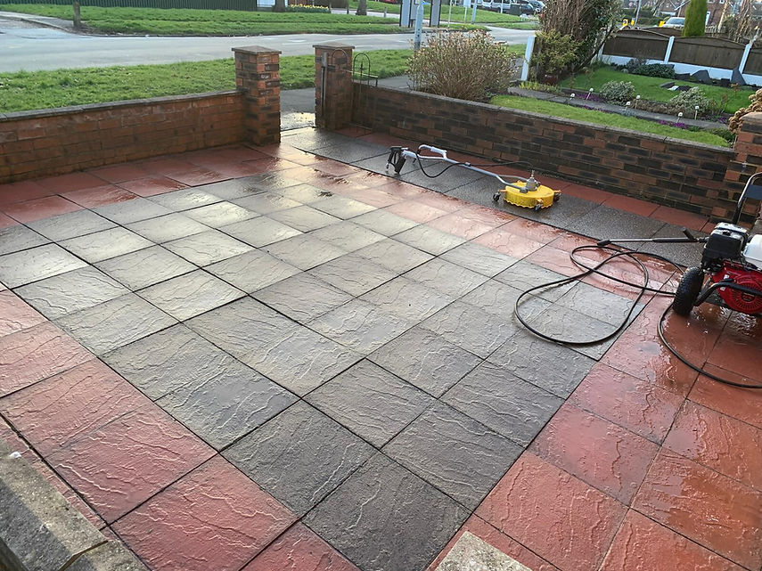 A garden with a patio, cleaning equipment laid out, cleaned by Jet Star