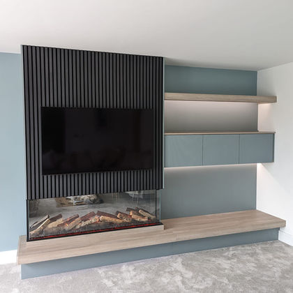 Modern media wall with TV, fireplace, and shelving