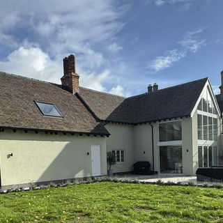 Large modern home in the country, balcony, skylights, clear skies, outdoor seating area