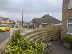 Wooden garden fence installed in front of house