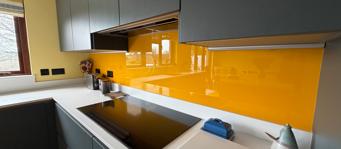 Modern kitchen with orange glass backsplash