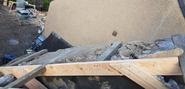 Support beams being installed in an old building, wooden beams, dark stones