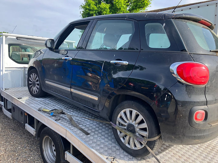 Black minivan being collected via van by KCB