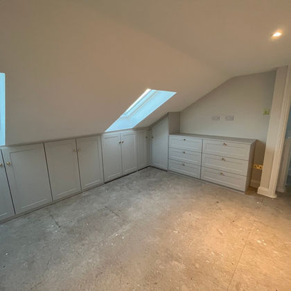 Fitted wardrobes in a sloped ceiling room