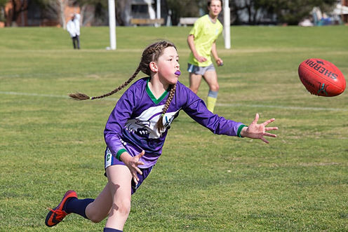 Brunswick Girl player running at football